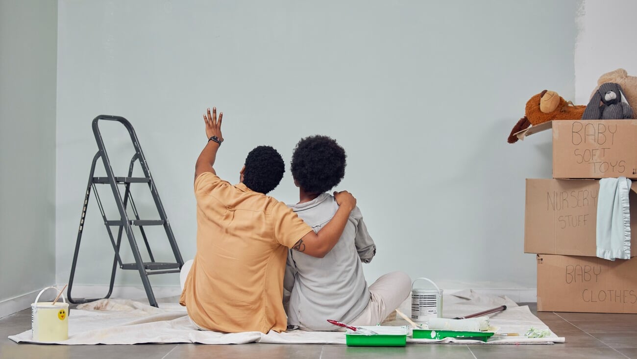 Planning, wall or black couple pointing in home renovation, diy or house remodel together on floor. Back view, painting or African man loves talking or working with teamwork in decoration with woman; Shutterstock ID 2265499721