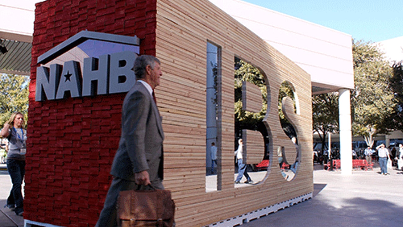 a person standing in front of a brick building