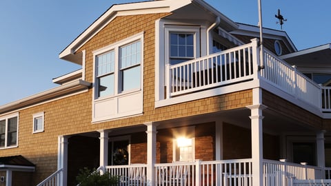 a house in front of a brick building