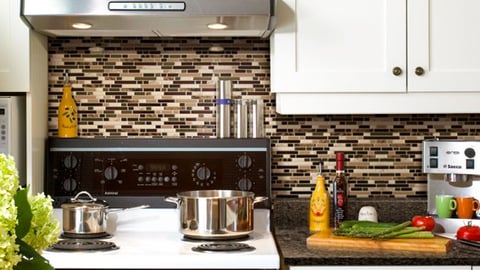 a stove top oven sitting inside of a kitchen counter