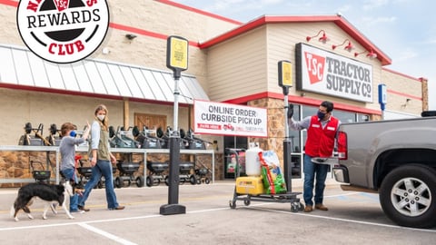 a group of people standing in a parking lot