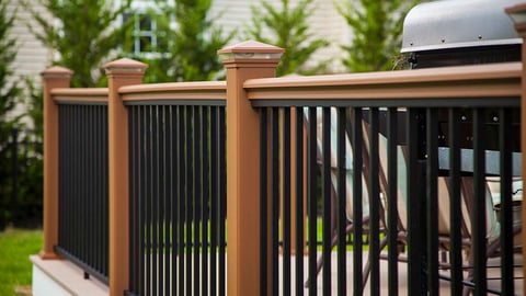 a chair sitting in front of a fence