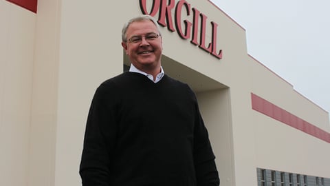 a man standing in front of a sign