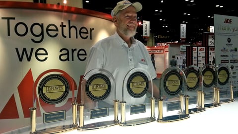 a man standing next to a clock