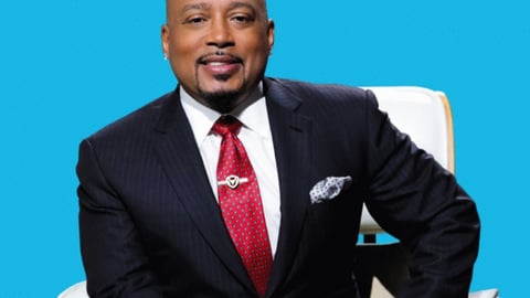 Daymond John wearing a suit and tie