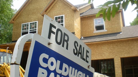 a street sign in front of a house