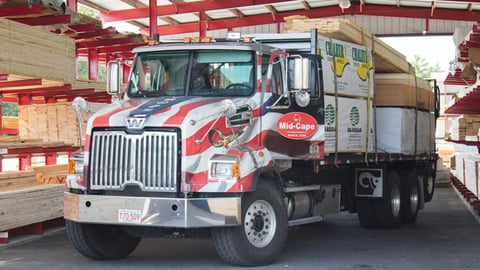 a truck that is driving down the street