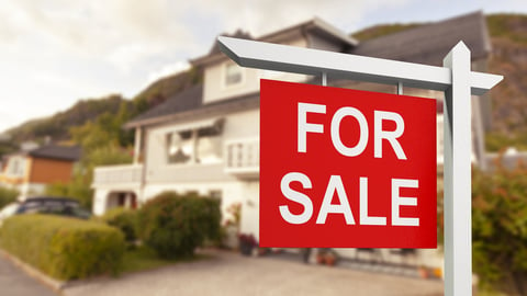 a sign in front of a house