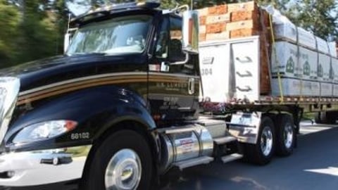 a truck driving down a street