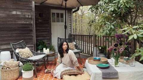 a person sitting at a table in front of a building