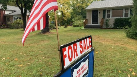 a large lawn in front of a sign