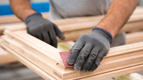 a man sitting on a wooden bench