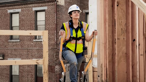 a person standing in front of a brick building