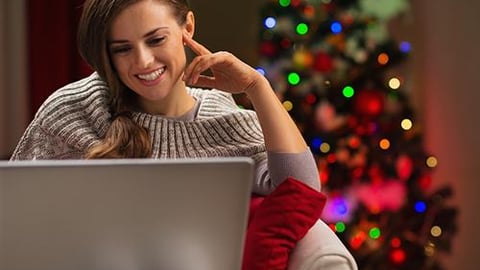 a woman sitting in front of a laptop