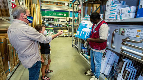 a group of people standing in front of a store