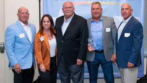 David Weekley (center) and 84 Lumber's Billy Ball (second from right) along with representatives from both companies.