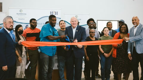 HBI CEO Ed Brady takes part in a ribbon cutting ceremony in Houston.