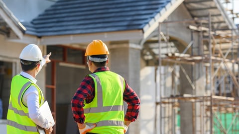 Construction crew in front of house