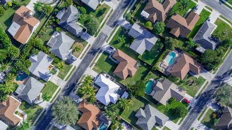 Aerial summer view of warm sunny neighborhood community roofs with diagonal streets and lots of houses with pools and palm trees. ; Shutterstock ID 1318716863