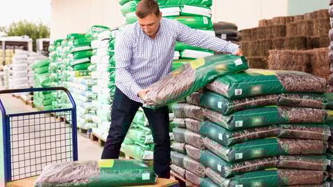 Glad   Man choosing compost soil in plastic bags in hypermarket .; Shutterstock ID 1627452460