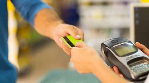 customer paying with credit card at supermarket; Shutterstock ID 196043063