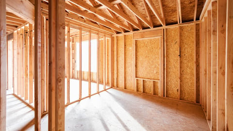 Wood framing and flooring structure with golden sunlight shining through window frame at empty room. New construction house, framework of real estate development industry. Renovation, building concept; Shutterstock ID 2264578825