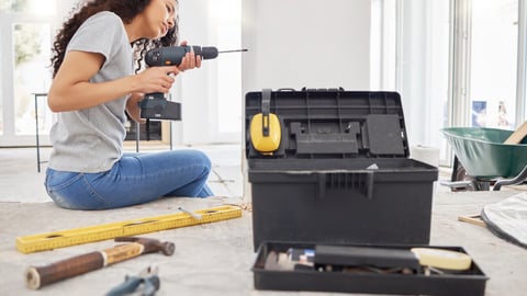 Construction, drill and wall with DIY woman in home for decoration, maintenance or repairs. Design, power tools and project management with person in apartment for building, improvement or remodel; Shutterstock ID 2477762321