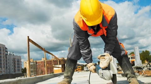 Builder worker with grinder machine cutting metal parts at construction site; Shutterstock ID 86230687