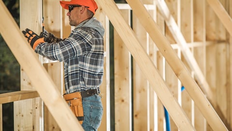 Caucasian Contractor Worker in His 30s with Drill Driver Attaching Wooden Frame Elements. Industrial Theme. Wood House Frame Construction; Shutterstock ID 1606599943