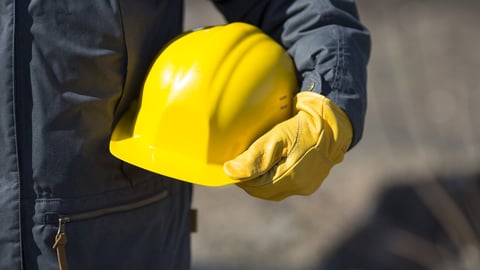 hand of worker with yellow hard-hat,natural light; Shutterstock ID 186660653