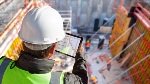 civil engineer or architect with hardhat on construction site checking schedule on tablet computer; Shutterstock ID 1039121731