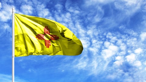 National flag State of New Mexico on a flagpole in front of blue sky; Shutterstock ID 1444166408