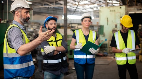 Professional Caucasian manager engineer in safety uniform is training industry factory worker, workshop factory operator, mechanical engineering team production in heavy industrial manufacture factory; Shutterstock ID 2149854693