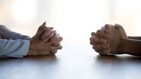 Close up clasped female hands of two businesswomen negotiate at table, confrontation concept, negotiators conflict, employees struggle for leadership at work, difficult job interview, hiring decision; Shutterstock ID 1511348126