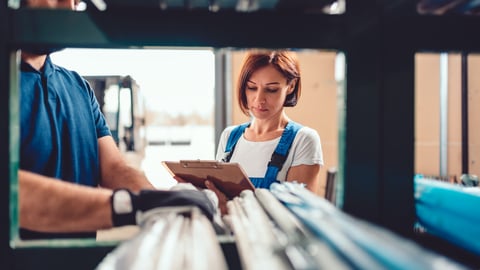 Female stock clerk checking inventory with a help of warehouse worker; Shutterstock ID 1521258107