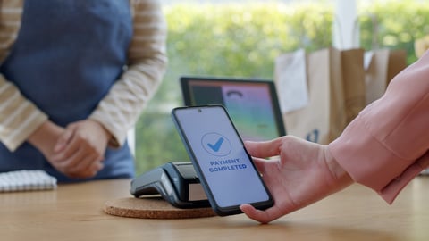 Close-up hand asia woman people work in small sme coffee cafe shop store owner use cashless wifi paywave nfc scan app smart pos reader sale in take out food drink order in urban city life contactless.; Shutterstock ID 2051361212