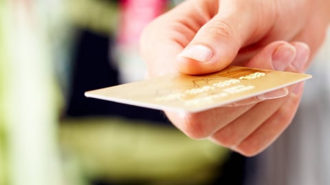 Close-up of credit card in human hand in the shop; Shutterstock ID 51417604