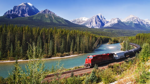 Train passing through Bow valley under the surveillance of mighty Rocky Mountains.; Shutterstock ID 515322646