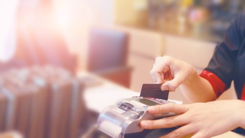 Moment of payment with a credit card through terminal.monochrome; Shutterstock ID 680478397