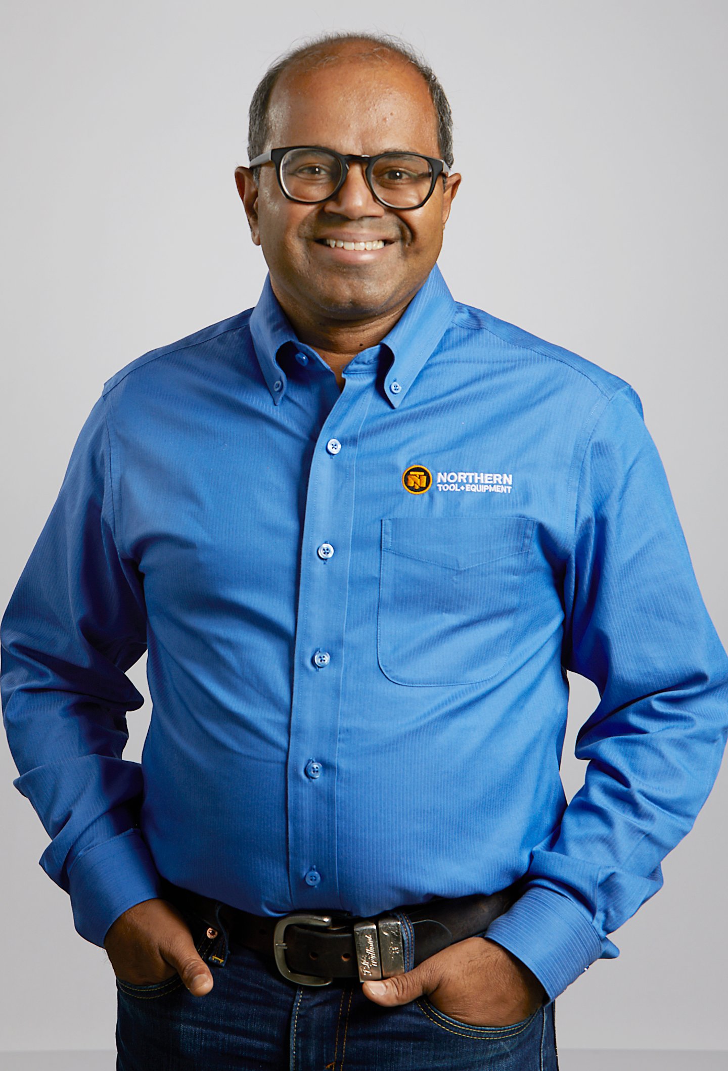 a man wearing glasses and a blue shirt