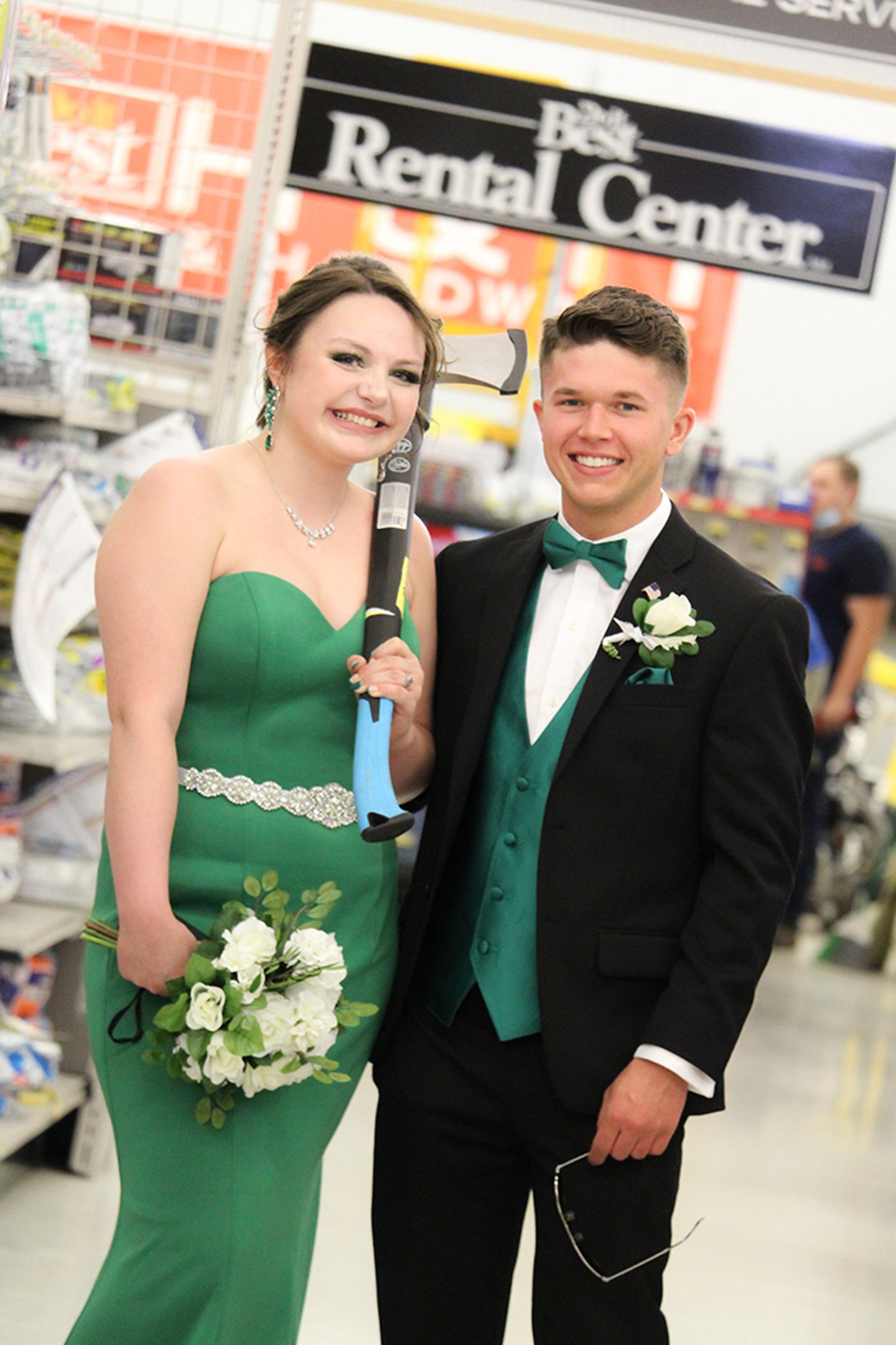 a woman standing next to a man in a suit and tie