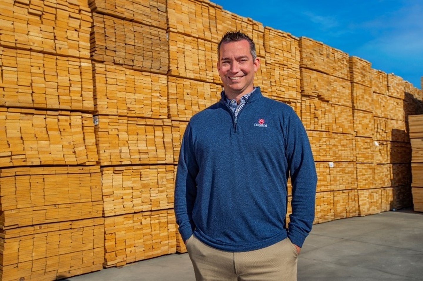 a man standing in front of a brick wall