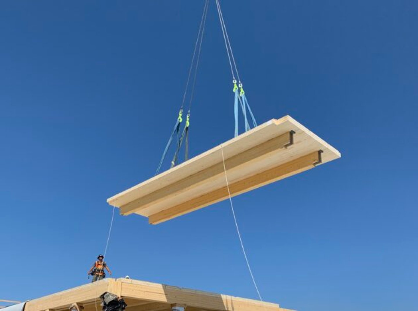 a person flying through the air on a clear blue sky