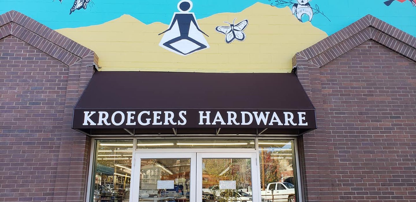 a sign above a storefront on a brick building