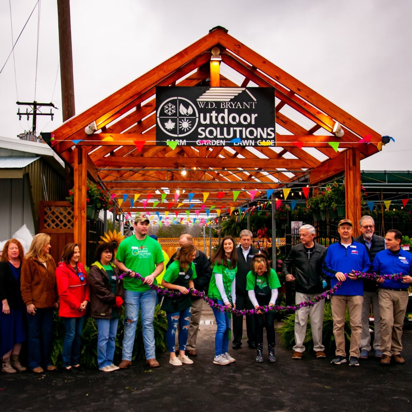 a group of people standing in front of a crowd posing for the camera