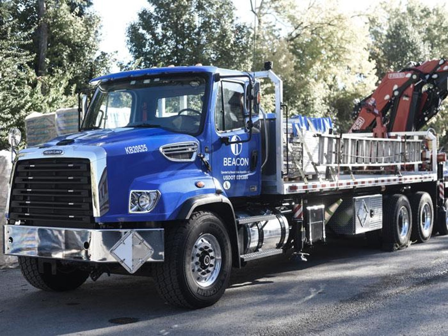 a blue truck parked on the side of a road