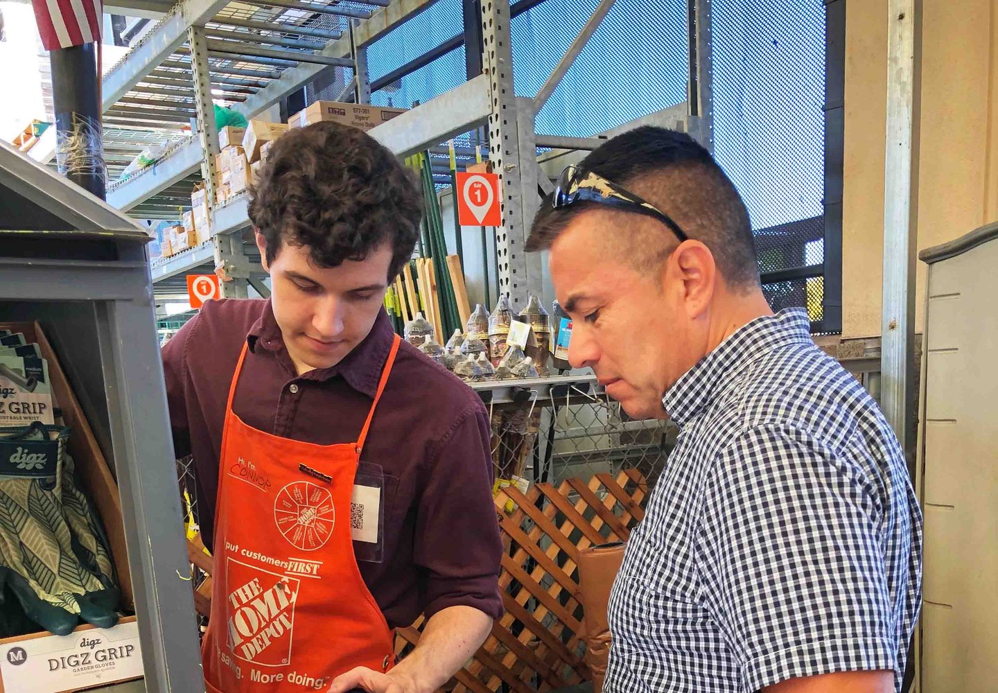 Home Depot employee at counter helping shutterstock