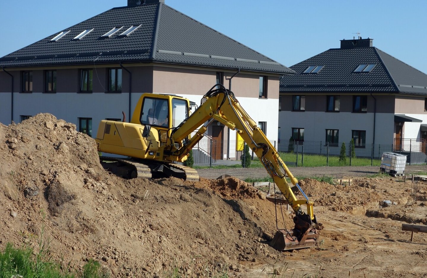 Crawler excavator on the construction site - work on the construction of the house has started; Shutterstock ID 2114787728