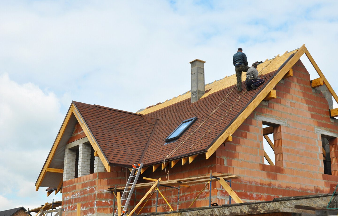 Roofing Construction and Building New Brick House with Modular Chimney, Skylights, Attic, Dormers and Eaves. ; Shutterstock ID 326838344