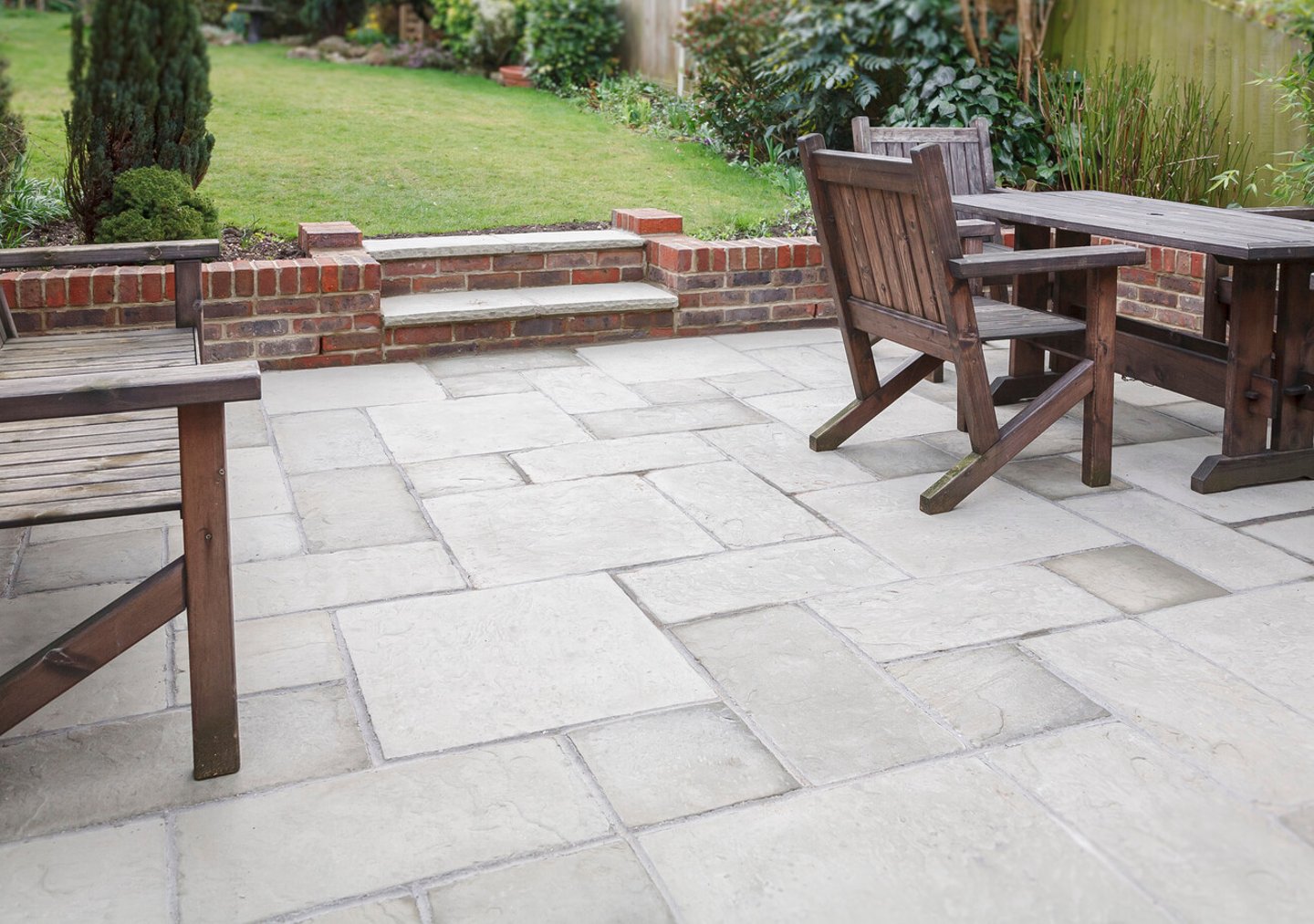 New flagstone patio and backyard, outdoor garden patio with furniture, UK; Shutterstock ID 1714019749